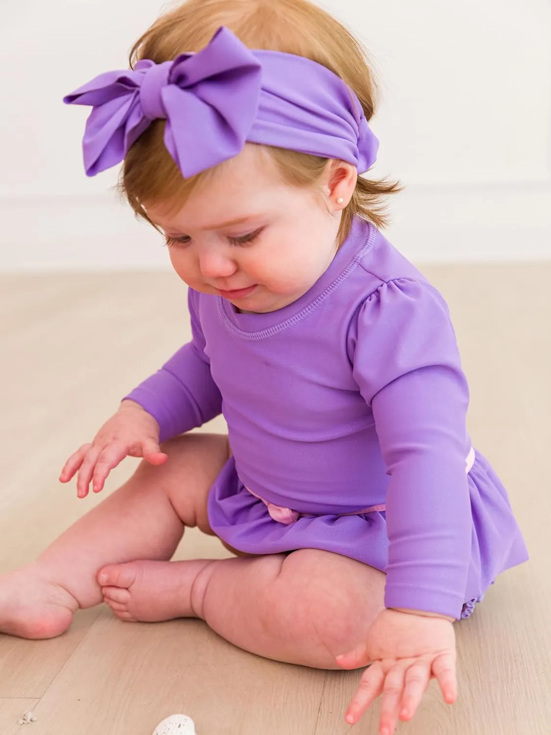 RuffleButts Baby Girls UPF50  Princess Long Sleeve Bow Skirted One Piece Swimsuit