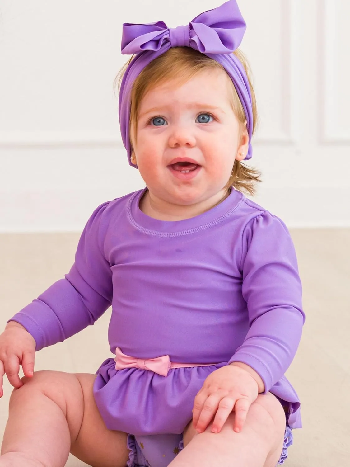 RuffleButts Baby Girls UPF50  Princess Long Sleeve Bow Skirted One Piece Swimsuit