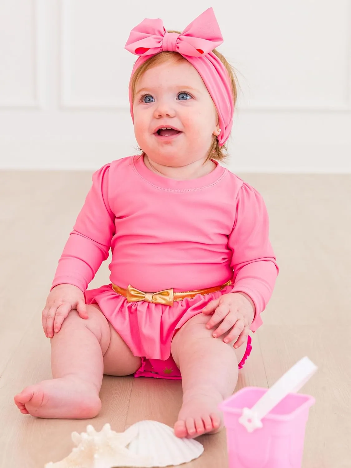 RuffleButts Baby Girls UPF50  Princess Long Sleeve Bow Skirted One Piece Swimsuit